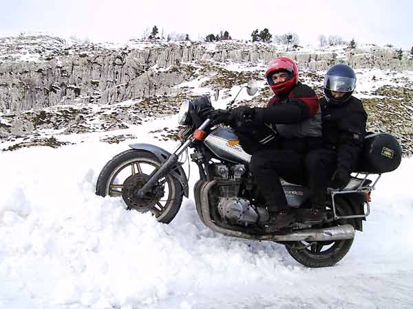 Met z'n tweeen op een motor in de sneeuw