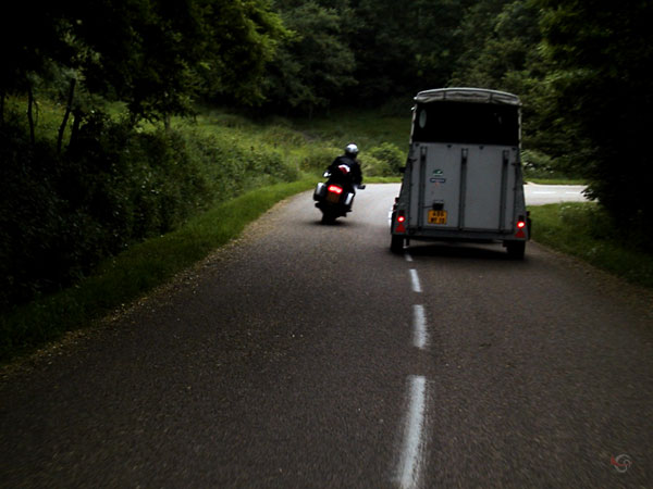 motor haalt paardentrailer in vlak voor de bocht